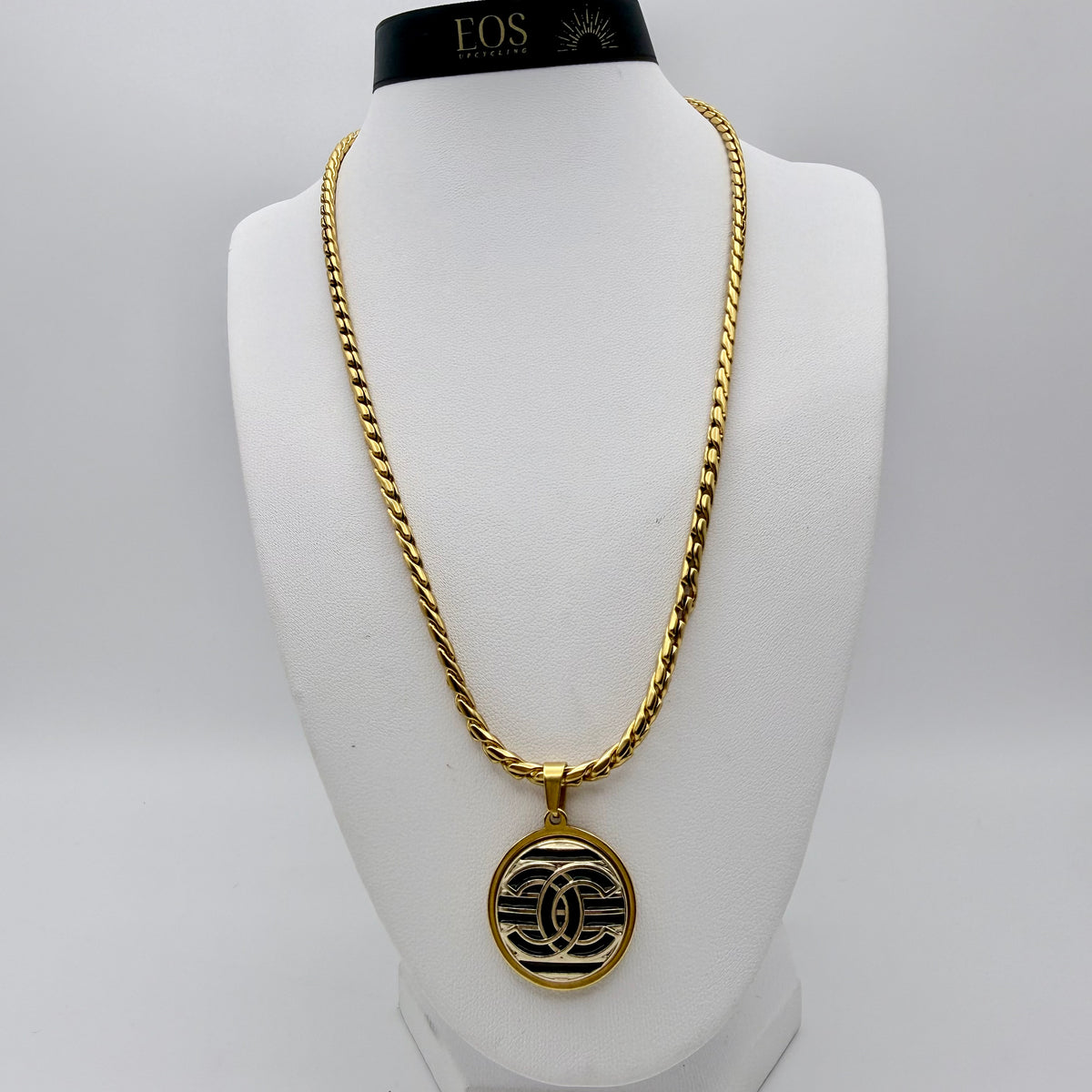 Joya artesanal sostenible con botón CHANEL reciclado.