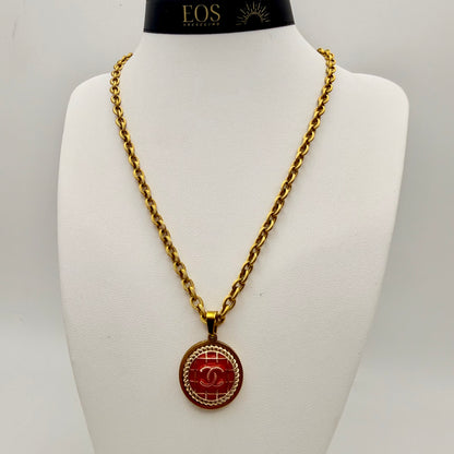 Joya artesanal sostenible con botón CHANEL reciclado.
